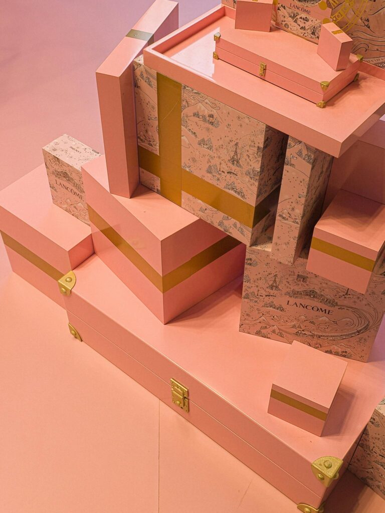 Elegant pink gift boxes with gold details create a festive and luxurious atmosphere.