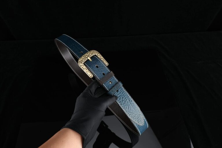 High-quality blue leather belt with intricate gold buckle, a perfect accessory for fashion enthusiasts.